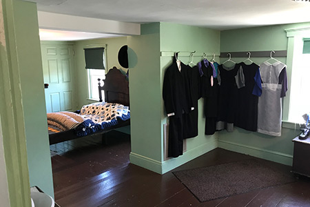 Educational Tours that Make Learning Fun for the Whole Family Clothing hanging in an Amish bedroom