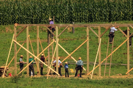 The 4 Core Values of the Amish Culture New Providence, PA, USA - July 30, 2013: Amish farmers at a “barn raising” in rural Lancaster County.