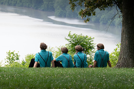 How the Amish Keep Cool in the Summer Heat Amish boys sitting by the riverfront