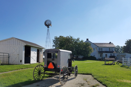buggy Lancaster Amish Buggy parked on property of Amish Village in front of a house
